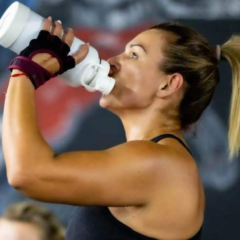 Girl drinking water after hard workout