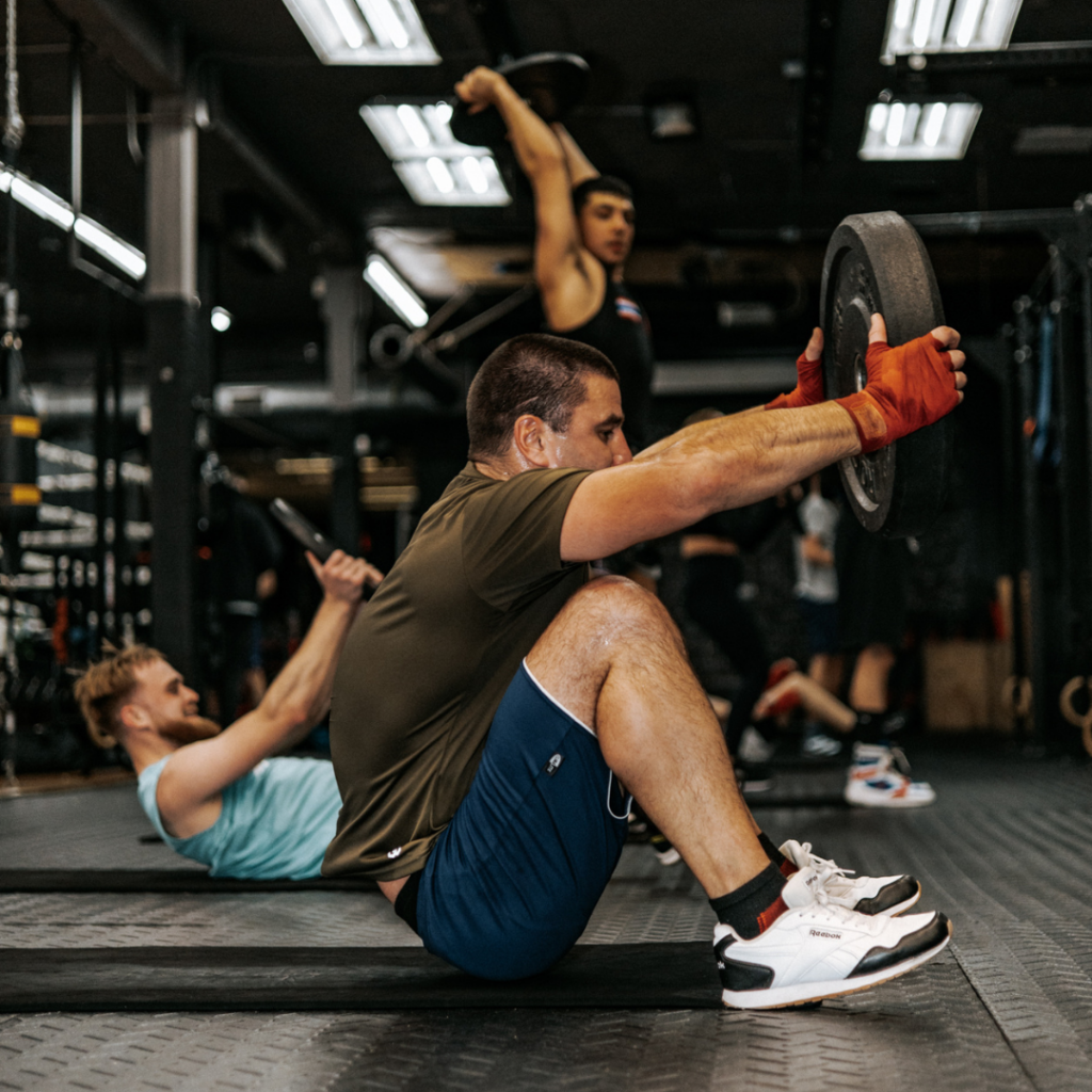 Core exercise with plates during boxing class
