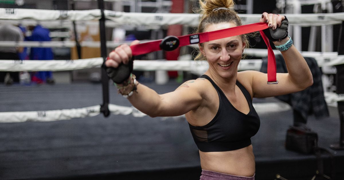 girl holding a myzone belt